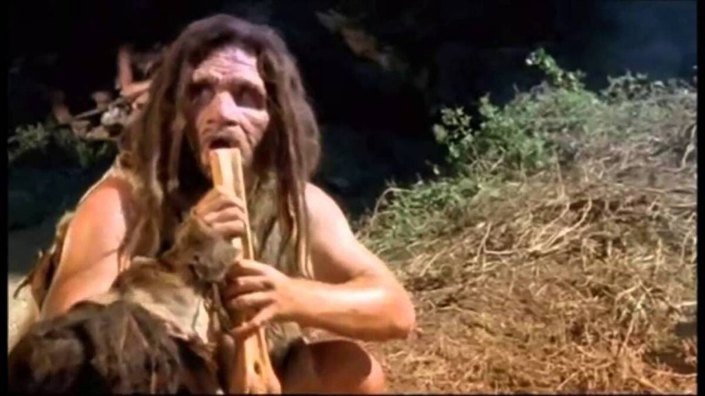 Hombre prehistórico tocando una flauta